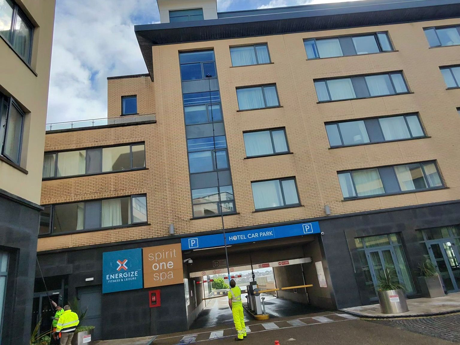 Atlantic Services crew cleaning the exterior glass of a hotel building with water-fed poles